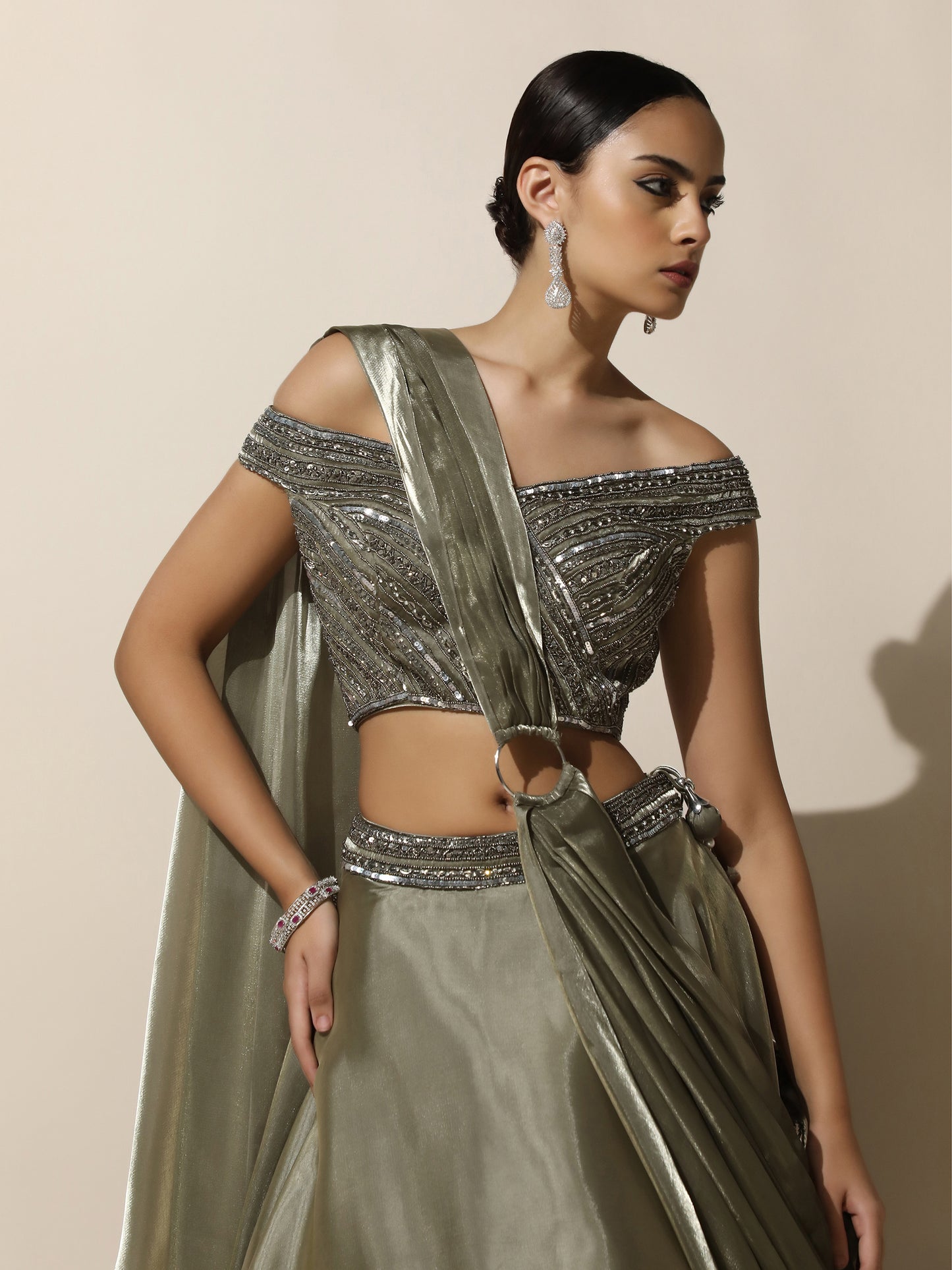 Olive Green Off-Shoulder Lehenga with Pleated Shoulder Drape, Antique Embroidery and Ring Detail